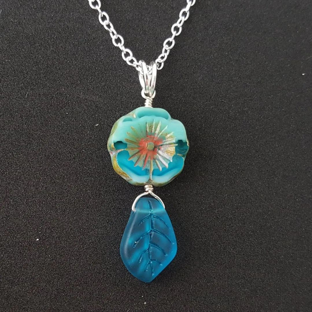 Handmade in Hawaii, Bohemian glass Hawaiian Flower bead with sea glass carved leaf, a beautiful necklace with matching earrings in my store