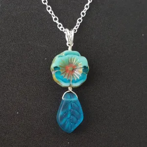 Handmade in Hawaii, Bohemian glass Hawaiian Flower bead with sea glass carved leaf, a beautiful necklace with matching earrings in my store